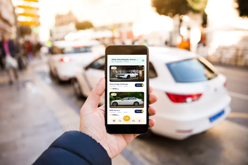 RentedWheels car listings on a phone